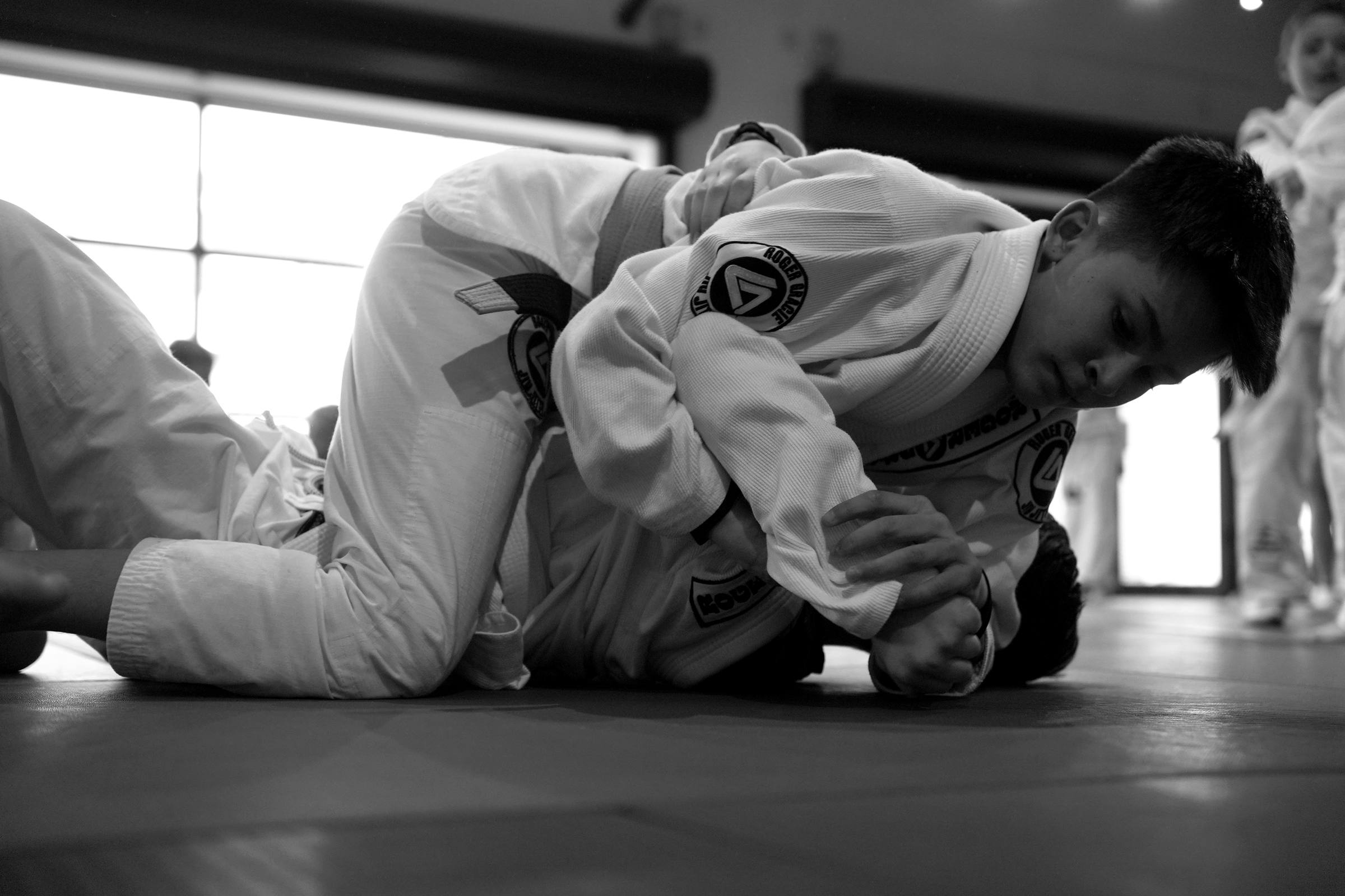 Two members training by the academy windows
