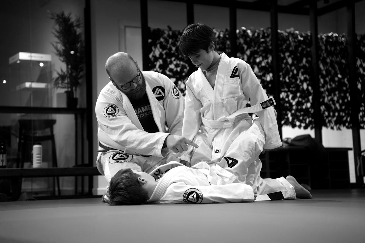 Coach teaching a technique to junior members